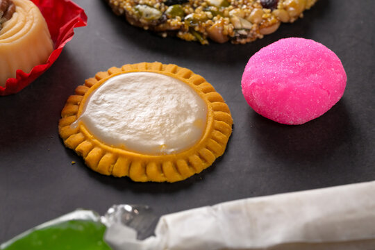 Close up of coconut dessert cocada and traditional Mexican confections on dark background