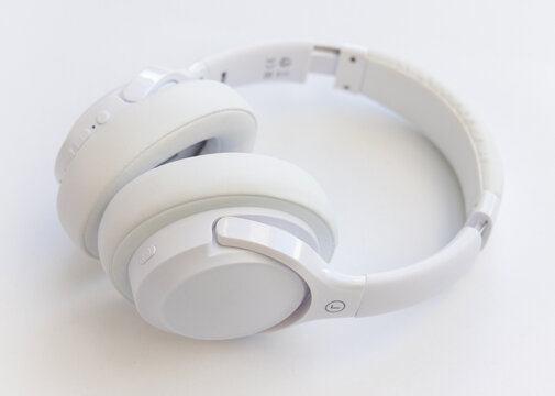 Modern white wireless headphones isolated on a white background