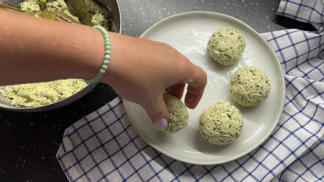 Process of shaping round dough buns with green herbs and pesto sauce