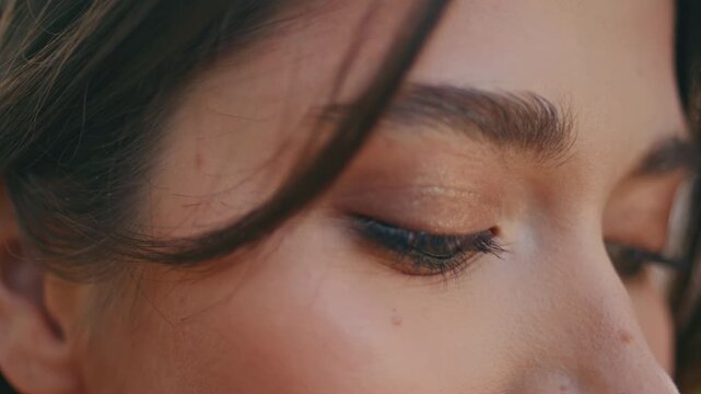 Woman opening eyes looking camera close up. Natural makeup eyelashes brows skin.