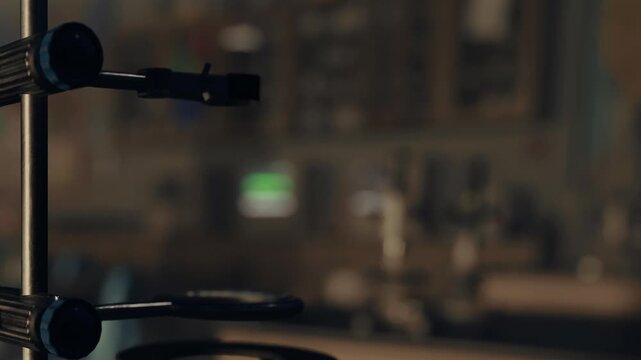 A camera focuses on specific equipment while the background is out of focus. This scene takes place in a workspace with various tools and objects visible.
