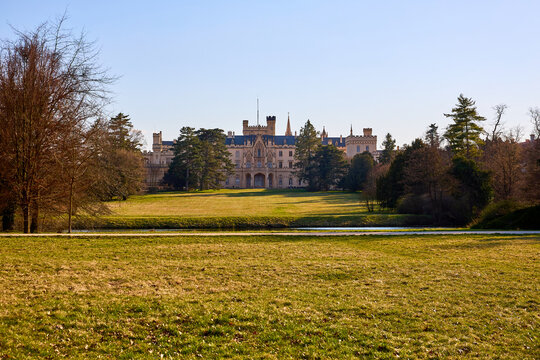 Scenic view of historic castle with vast grounds and clear blue sky