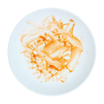 dirty red sauce on white circle plate isolated on white.