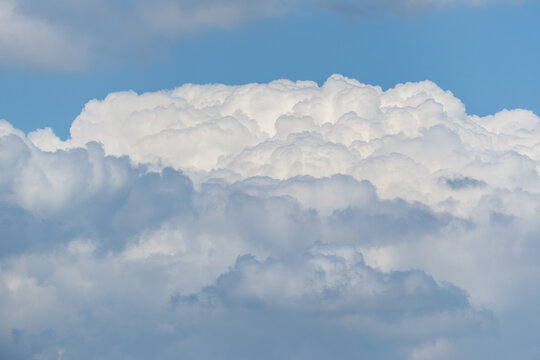 View of white cumulus clouds drifting across a clear blue sky in Jahanian, Pakistan.