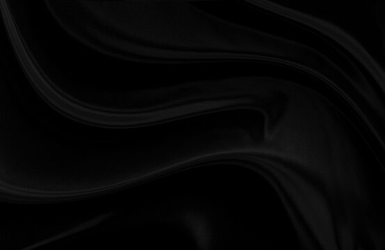 Black gray satin dark fabric texture luxurious shiny that is abstract silk cloth background with patterns soft waves blur beautiful.
