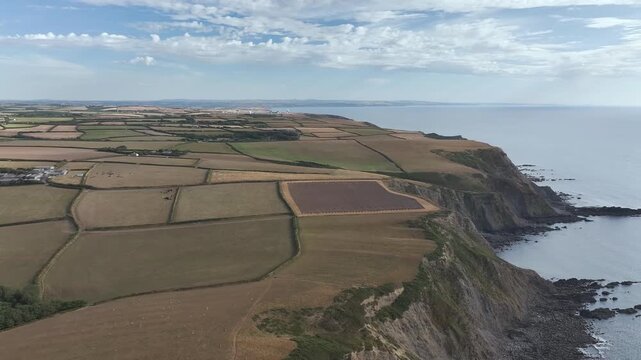 Cliffs and Farms over North Devon and Cornwall Coastpath Border from a drone, Welcombe Mouth Beach, Devon, Cornwall, England, Summer 2026