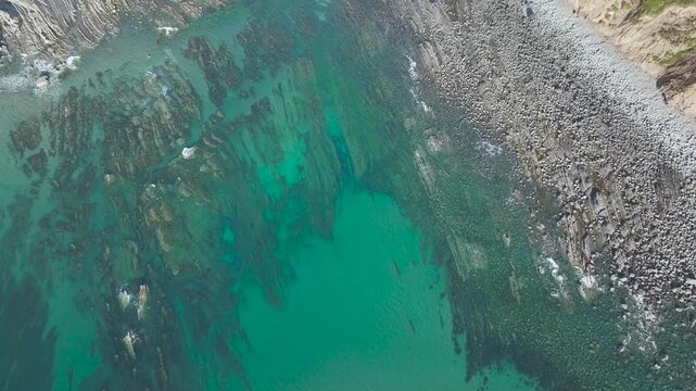 Top Down view of Cliffs and Farms over North Devon and Cornwall Coastpath Border from a drone, Welcombe Mouth Beach, Devon, Cornwall, England, Summer 2026