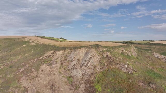 Cliffs and Farms over North Devon and Cornwall Coastpath Border from a drone, Welcombe Mouth Beach, Devon, Cornwall, England, Summer 2026