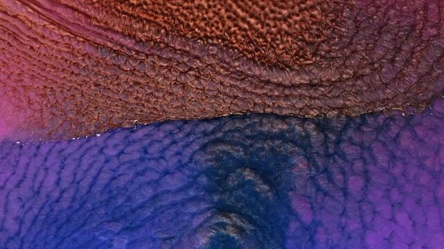 Mixing different colors of alcohol ink in a close-up view