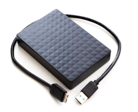 Black external hard drive with USB cable on white background