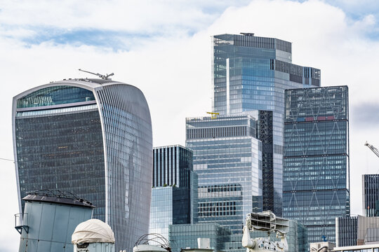 View of the modern skyline of the City of London, featuring the 20 Fenchurch Street building and other glass skyscrapers under a cloudy sky in London, England, United Kingdom.