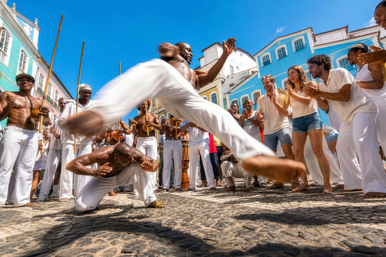 Travelers experience an energetic capoeira roda with local performers in colorful Salvador, Brazil, combining cultural tourism, movement and authentic urban travel.