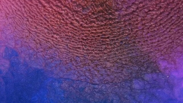 Mixing colored alcohol inks in a close-up view of art in progress