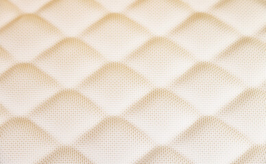 Naklejka premium Quilted cream fabric creating diamond pattern texture
