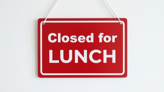 A rectangular red sign with white lettering indicates a business is closed for lunch hanging against a white wall signage lunchtime redsign