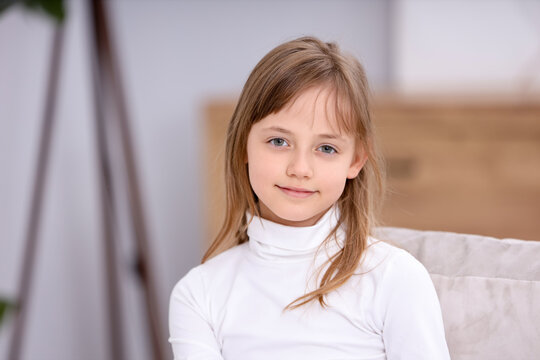 Portrait of cute little girl at home. Space for text