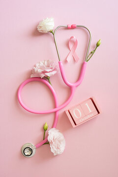 Pink stethoscope and ribbon on a vertical soft pink background for Breast Cancer Awareness month medical campaign and October health observance