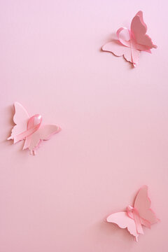 Breast Cancer Awareness month concept with pink butterfly ribbons on soft pink vertical background for hope and support