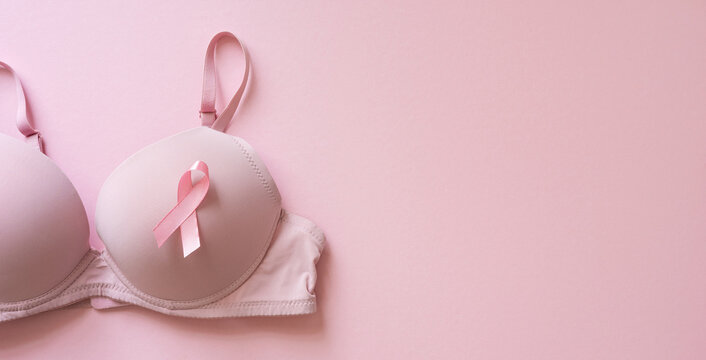 Pink bra with ribbon on soft pink banner background for Breast Cancer Awareness Month and support campaign