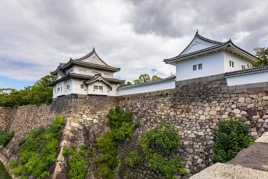 Peaceful castle moat landscape at Osaka Castle with reflections and fortified embankments in Osaka Japan.
