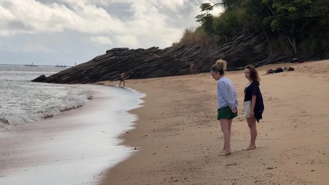 People Enjoying Beach Activities at Feiticeira Beach in Ilhabela, Brazil