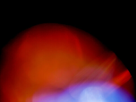 Abstract glowing colorful light leaks on dark background for special effects and design. Beautiful light streaks. Random color and shape.