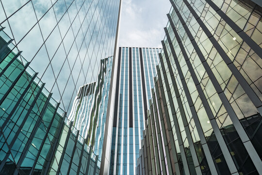 View of modern glass skyscrapers reflecting the sky in the financial district of London, England, United Kingdom.
