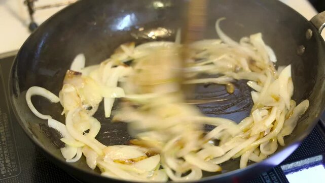 Caramelized onions saut&eacute;ed in an iron frying pan.