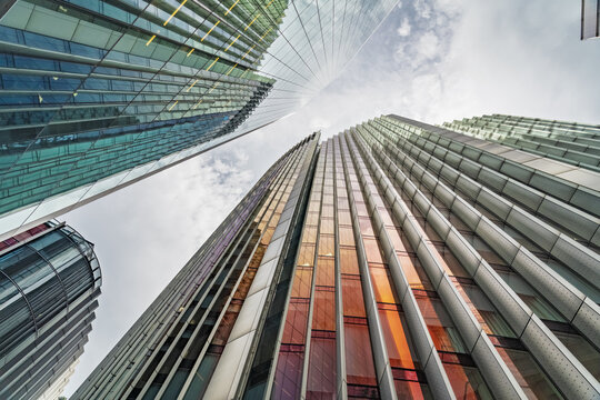 View of modern glass skyscrapers with reflective facades and geometric architectural lines in the City of London, London, England, United Kingdom.