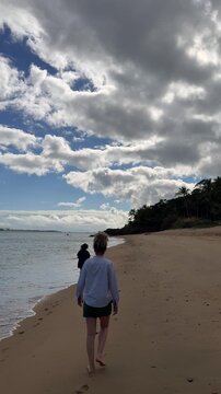 People Enjoying Beach Activities at Feiticeira Beach in Ilhabela, Brazil