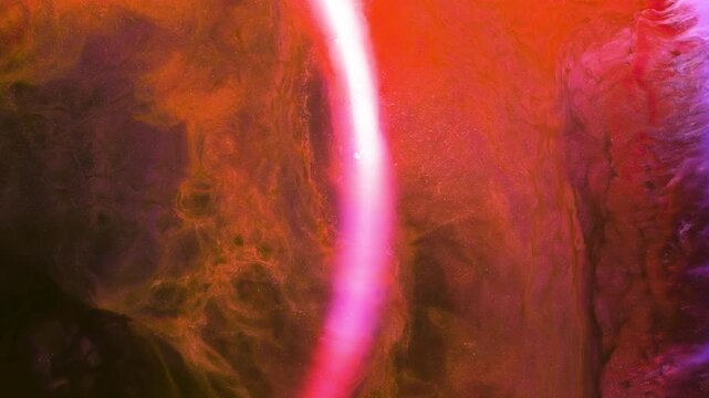 Mixing different colored alcohol inks to create colorful designs