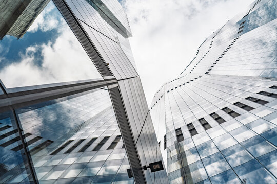 View of modern glass skyscrapers with reflective facades and clouds in the sky in London, England, United Kingdom.