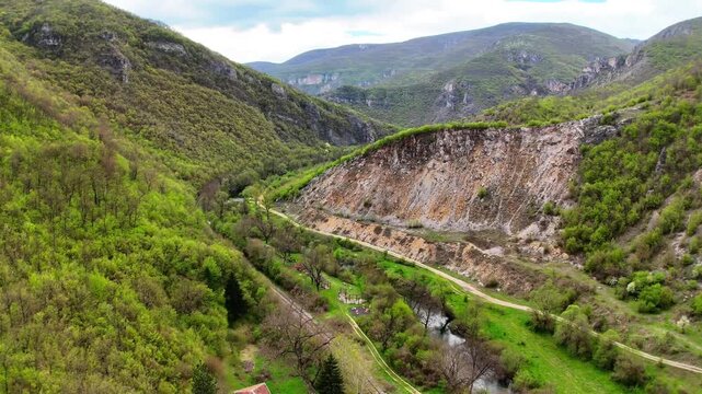 Aerial 4K Drone View of Zemen Gorge with Railway Track Through Rocky Mountain Valley Bulgaria