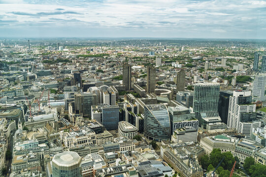 View of the dense urban skyline featuring modern skyscrapers, historic buildings, and bustling city streets in London, England, United Kingdom.