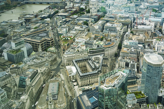 View of the dense urban landscape of the City of London featuring historic and modern architecture, intricate street patterns, and rooftops in London, England, United Kingdom.