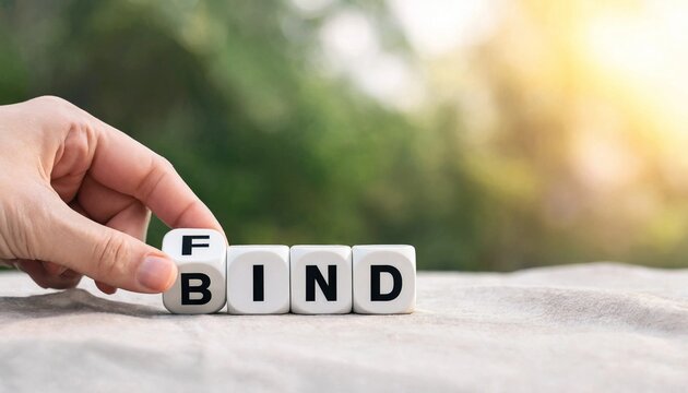 Hand rotating white letter block to change the word bind to find