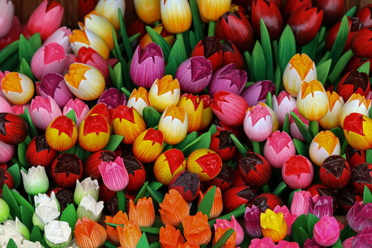 Colorful wooden tulip souvenirs filling a market display. Netherlands 