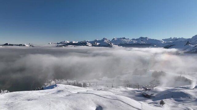 Aerial Drone View Over Swiss Alps Cloud Inversion with Snow Covered Winter Mountain Landscape