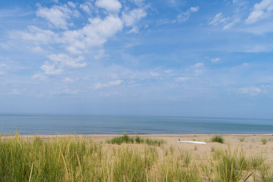 Paddleboard on sandy Lake Michigan beach in Holland, Michigan