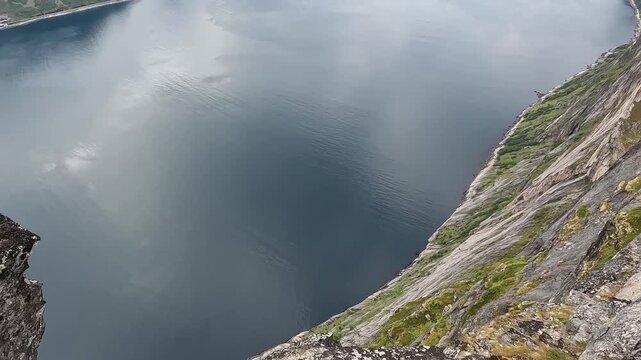 Sheer Cliff Face of Segla Mountain Viewed from Drone with Norwegian Fjord Below in Northern Norway
