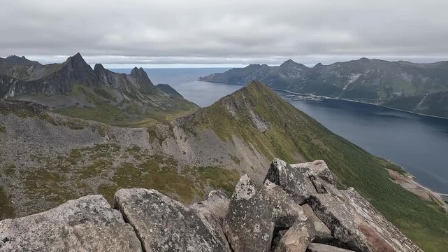 Aerial Drone View of Jagged Segla Mountain Ridge and Norwegian Fjord Panorama in Northern Norway