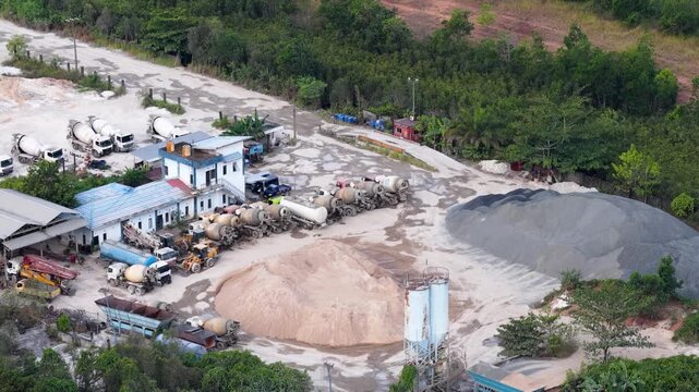 Large industrial construction site with cement mixers and stockpiles of sand and gravel