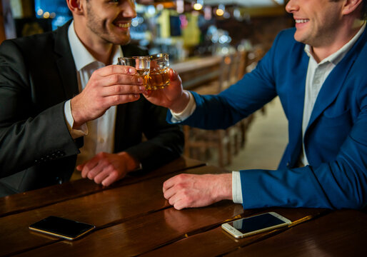 Businessmen Toasting Whiskey Together.