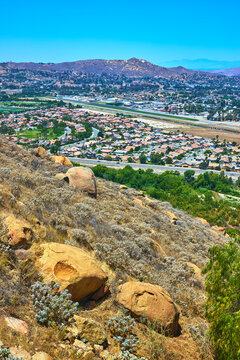 Hillside Boulders Overlook Suburban Neighborhood and Mountains San Bernardino California