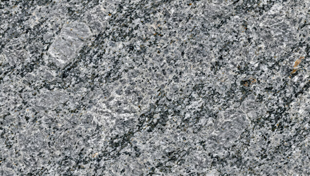 Natural grey granite stone texture with speckled quartz mineral grains for architectural countertop slab
