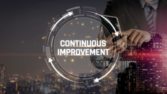 Businessman Using Smartphone with Continuous Improvement Concept Over Cityscape at Night for Growth and Efficiency in Modern Work Environment Sigmoid