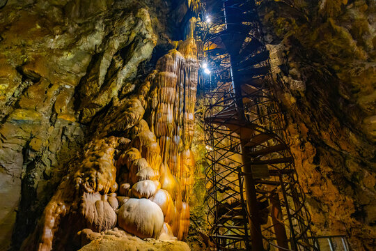 Moaning Caverns stairway glows amid illuminated formations