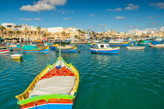 Traditional colorful fishing boats in Marsaxlokk harbor, Malta