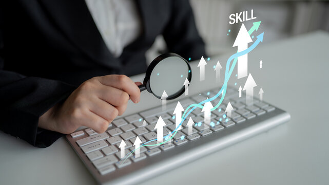 Business Growth Concept with Magnifying Glass on Keyboard Showing Skill Development in Digital Environment with Upward Trend Arrows and Graphs Haptic.
