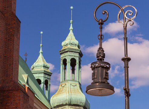 Historic Church Towers and Street Lamp in Poznan, Poland